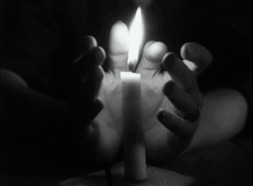 Ярко горящая свеча между двух ладоней, как символ вечност...