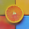 Апельсин на цветном фоне