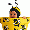Ребенок пчелка выглядывает из банки с медом