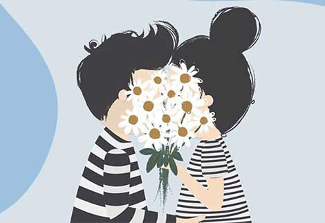 Мальчик с девочкой целуются за букетом цветов